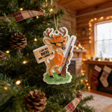 A Christmas ornament in the shape of a deer, wearing sunglasses and holding a rifle, is hanging on a decorated Christmas tree.