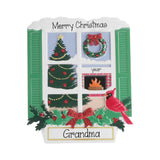 A personalized Christmas window plaque featuring green shutters, festive window scenes with a tree, wreath, garland, fireplace, and a red cardinal, with the text 'Merry Christmas' at the top and 'Grandma' on a nameplate at the bottom.