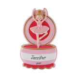 A pink and red decorative object featuring a figurine of a ballerina in a pink tutu and ballet slippers.