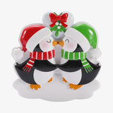 Decorative penguin ornament with festive hats and scarves on a white background